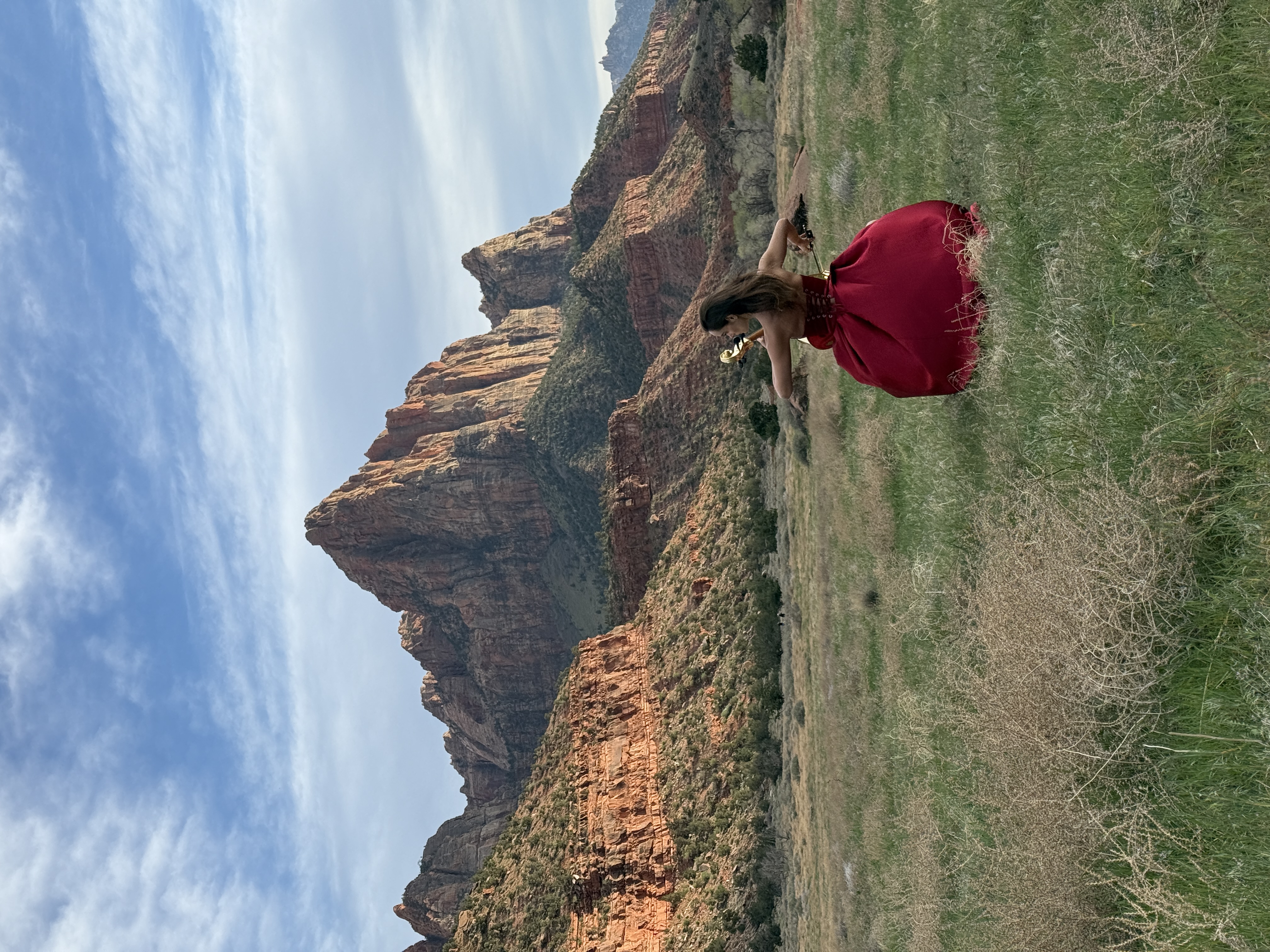 Golden Cello Girl performing in Zion National Park with red rock formations